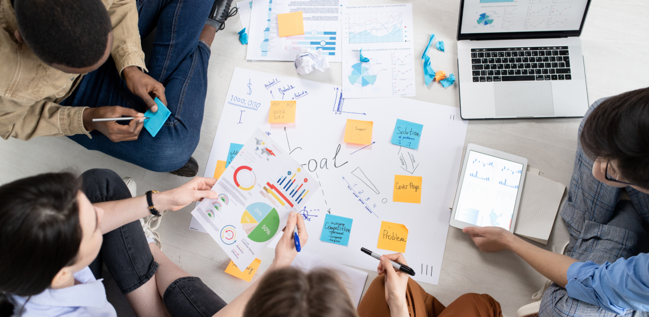 krāsainas piezīmju lapiņas, atvērts portatīvais dators, projektu vadības grupa